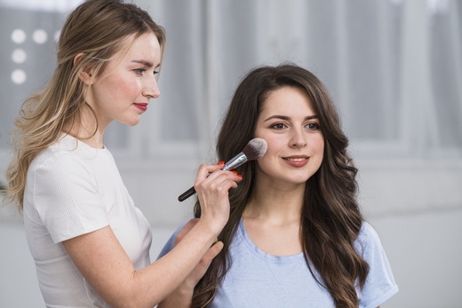 makeup-artist-covering-model-face-by-powder.jpg